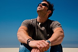 hansdome guy sitting arms oround knees